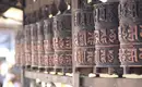 Gebetsmühlen in Kathmandu Reihe von Gebetsmühlen mit tibetischen Schriftzeichen in Nepal