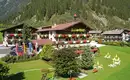 Unser Hotel Almhof Danler im Stubaital Das Hotel Almhof Danler inmitten der malerischen Berglandschaft des Stubaitals.