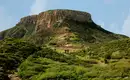 La Gomera: den Roque Agando erkunden Panoramablick auf Roque Agando, umgeben von grüner Vegetation auf La Gomera.