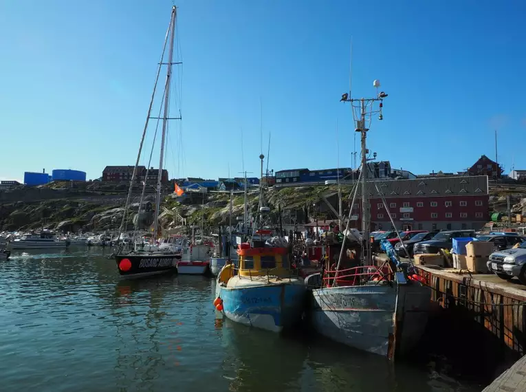Hafenansicht auf Grönland Blick auf Fischerboote im Hafen von Grönland unter blauem Himmel.